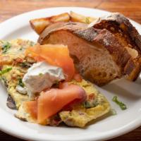 3 Egg Omelet · Smoked salmon, tomato, goat cheese, spinach and mushroom topped with sour cream served with ...