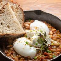 Turkish Eggs · Poached eggs in tomato sauce (grandma’s recipe) mixed with cannellini beans, labneh, pistach...