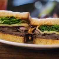 Grilled Flank Steak Panini · Baby arugula, caramelized onions, swiss cheese and harissa sauce on ciabatta bread with cris...