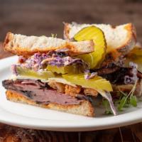 Pastrami Stack · Hot pastrami, Swiss cheese, onion rings, red cabbage slaw, and pickle dazzled with Kimchi Ai...
