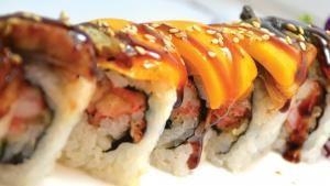 Tiger Roll · Spicy. Inside, spicy salmon crunch. Outside, salmon and eel with spicy mayo.