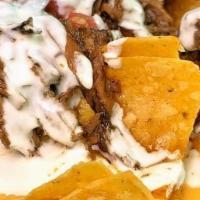Loaded Nachos · corn tortilla chips, house queso, pulled pork or smoked chicken, pico de gallo, sour cream a...
