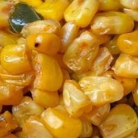 Cajun Corn · kernel corn, charred peppers and onions in a cajun spice blend