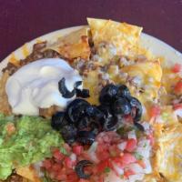Nachos · Chips topped with ground beef, cheese, pico, guac, sour cream and black olives.