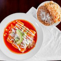 Rancheras · Topped with tomato sauce, lettuce, onions, tomatoes, sour cream, avocado and cotija cheese.