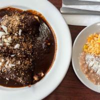 Mole · Topped with thick dark sauce (contains peanuts), cotija cheese and onions.