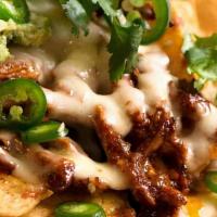 Nachos · Corn tortilla chips topped with melted cheese