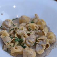 Truffled Moneybags · ricotta-filled beggar's purse-shaped pasta, white truffle-infused cream sauce.