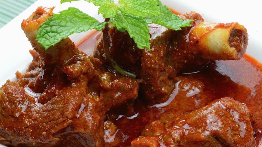 Achari Gosht · Tender meat pieces simmered in a blend of pickled sauce.