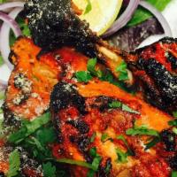 Tandoori Chicken · Chicken marinated in red chilies, spices and cooked in a tandoor.