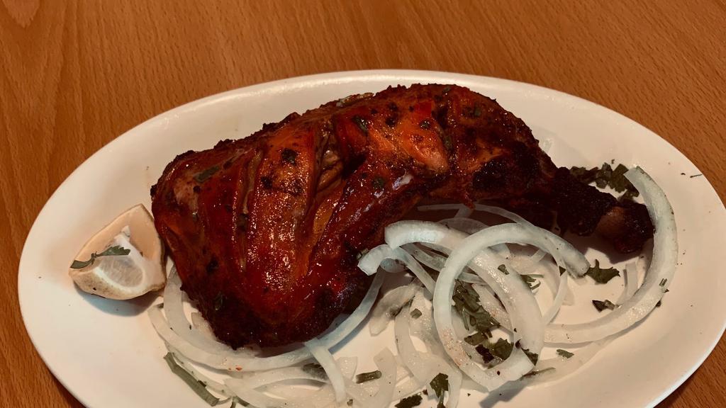Chicken Tandoori · Roasted chicken marinated in yogurt, lemon juice and spices.