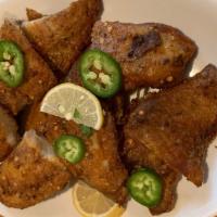  Fried Fish · Tilapia fish fried with spices and herbs served with chat masala and chutney (sauce).
