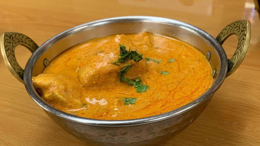 Chicken Tikka Masala · Boneless chicken cooked special butter, yogurt, tomato sauce and garnished with green chilies.