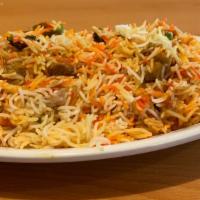 Goat Biryani · Spiced goat cooked in herbs and spices with basmati rice.