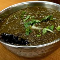 Palak Paneer · Spinach and cheese cooked in  cream and spices