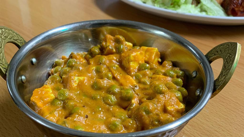 Matar Paneer · Green peas and Paneer pieces cooked with onions  and spices with tomatoes.