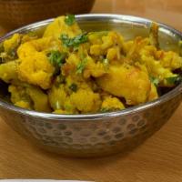 Aloo Gobhi · Potatoes and cauliflower cooked with fresh ginger, onion and spices.