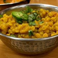 Dal Chana · Split bengal gram boiled in water with some turmeric, salt, then cooked with onions, red and...