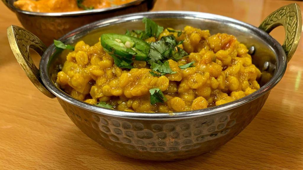 Dal Chana · Split bengal gram boiled in water with some turmeric, salt, then cooked with onions, red and green chilies, coriander and garam masala.