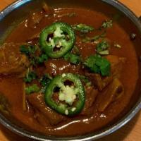 Goat Curry · Goat or lamb cooked in fresh herbs and spices.