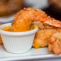 Camarones Con Coco · Coconut dipped jumbo shrimp lightly fried and served with delicate mango sauce.
