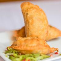 Empanaditas · Three small fried pastries turnover filled with ground beef.