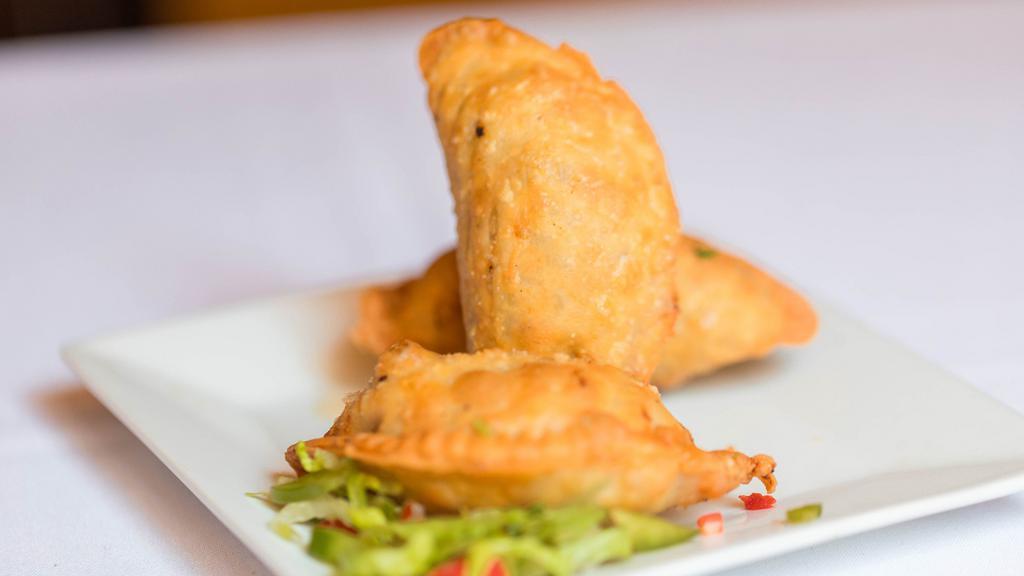 Empanaditas · Three small fried pastries turnover filled with ground beef.