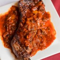Bistec Ranchero · Grilled sirloin steak, served with slowly cooked onions and poblano peppers, in guajillo mil...