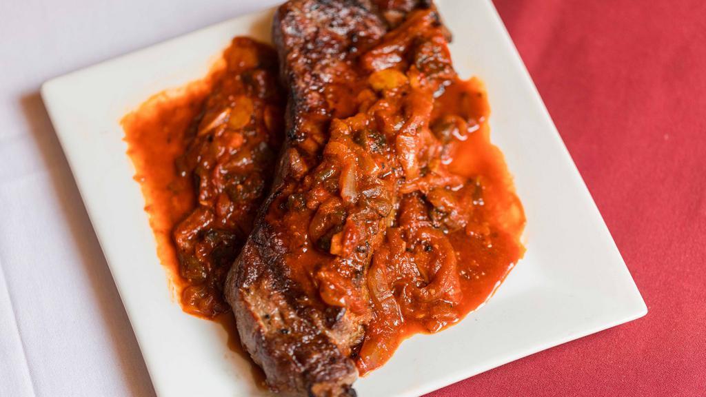 Bistec Ranchero · Grilled sirloin steak, served with slowly cooked onions and poblano peppers, in guajillo mild sauce.