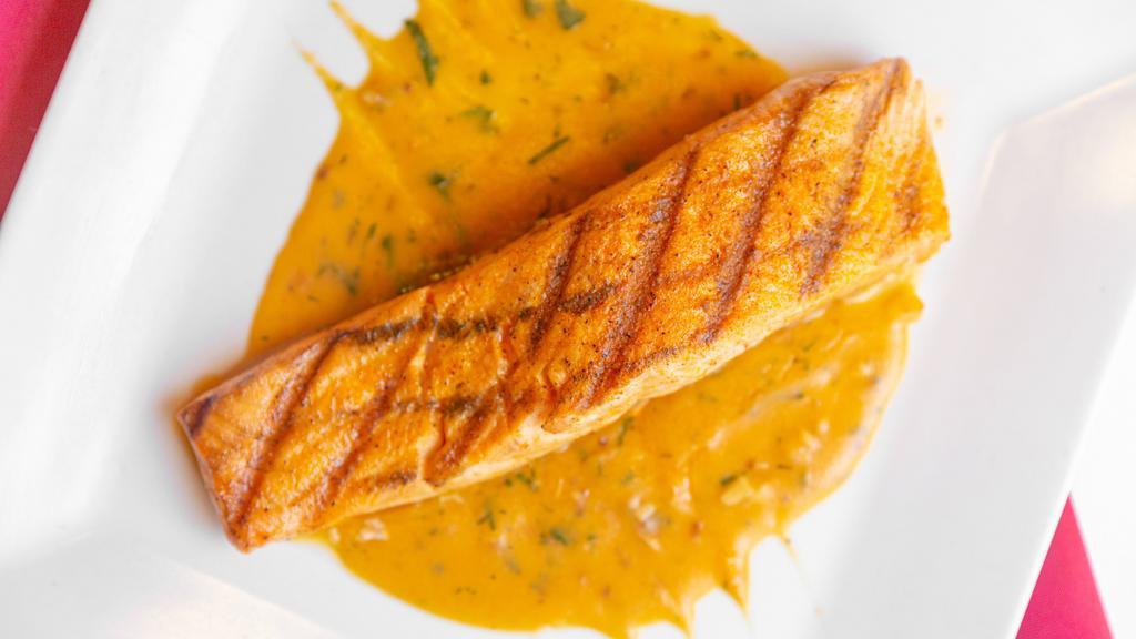 Salmon Asado · Fresh fillet of atlantic salmon broiled, served in a bed of fresh aromatic herb sauce.