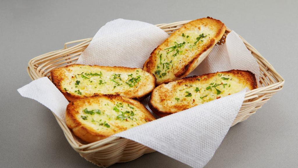 Garlic Bread · Garlic Bread Baked To Perfection Garnished with Herb Seasoning.