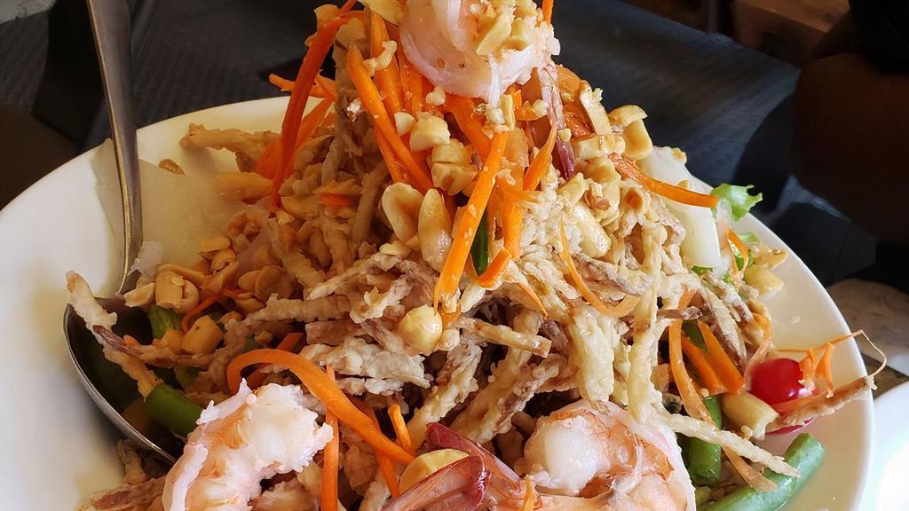 Crispy Papaya Salad · Spicy. The signature. Fried crispy papaya topped with shrimp, squid in spicy lime juice.