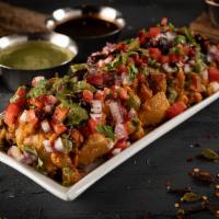 Samosa Chaat · A flavorful snack with chickpeas, samosa topped with yogurt and tamarind sauce