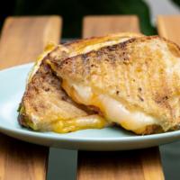Grilled Cheese · Three kinds of cheese (Fontina, aged Parmesan, Cheddar) melted into pesto, fresh tomatoes on...