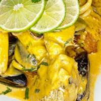 Filete De Pescado A Lo Macho: Con Salsa De Aji Amarillo, Mariscos, Papa Dorada Y Arroz Blanco  · Fish fillet with yellow chili sauce, seafood, golden potato and white rice