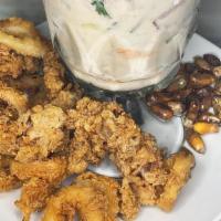 Leche De Tigre Con Chicharron De Calamar · Mini ceviche concentrated with fried calamari