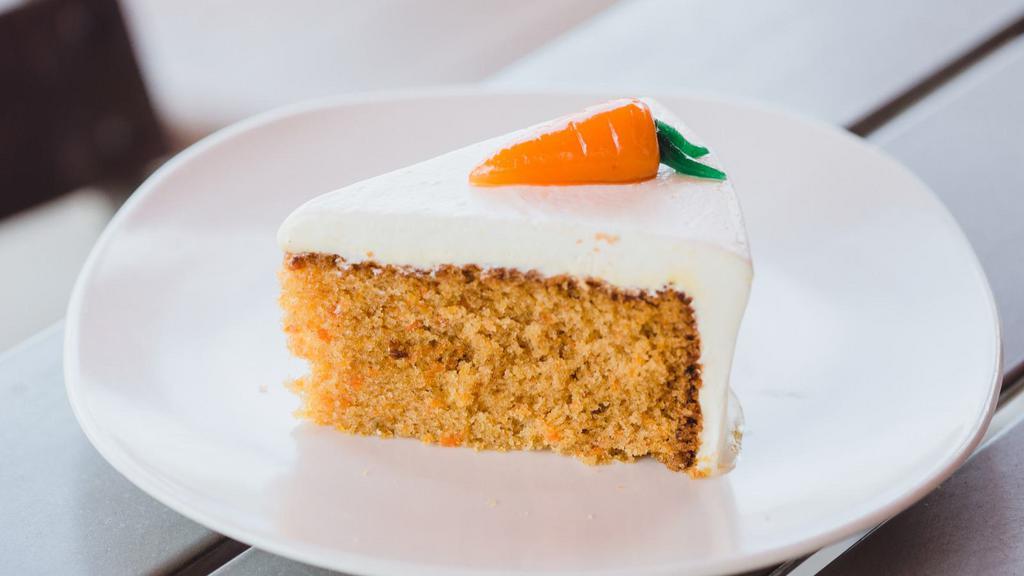 Carrot Cake · Sweet and moist spice cake, full of cut carrots and toasted nuts, and covered in cream cheese icing.
