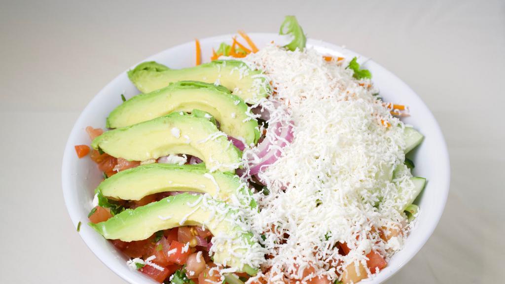 Goat Cheese & Avocado Salad · Goat cheese and avocado, romaine lettuce, shredded carrots, red onions, tomatoes, cucumbers, lemon, olive oil, and homemade the seasoning.