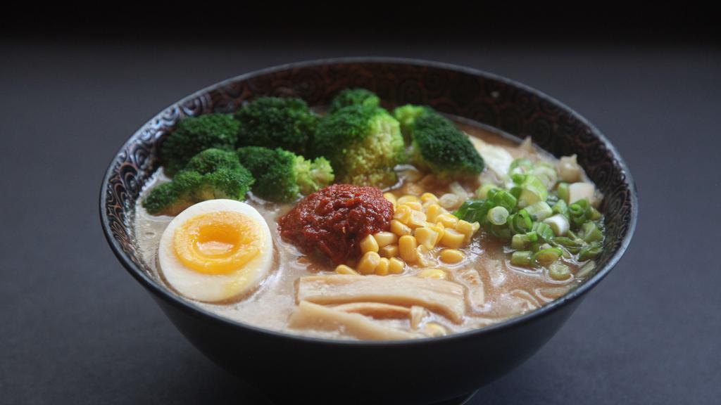 Kara Veggie Miso Ramen · Spicy noodle soup with miso broth. Topped with corn, menma, broccoli, scallion, bean sprouts, cabbage, egg, and onion.