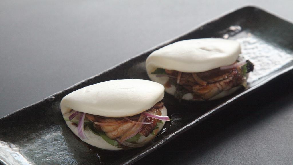 Buns · Pork, shrimp tempura or kani salad served with vegetable and sauce inside steamed soft bread.