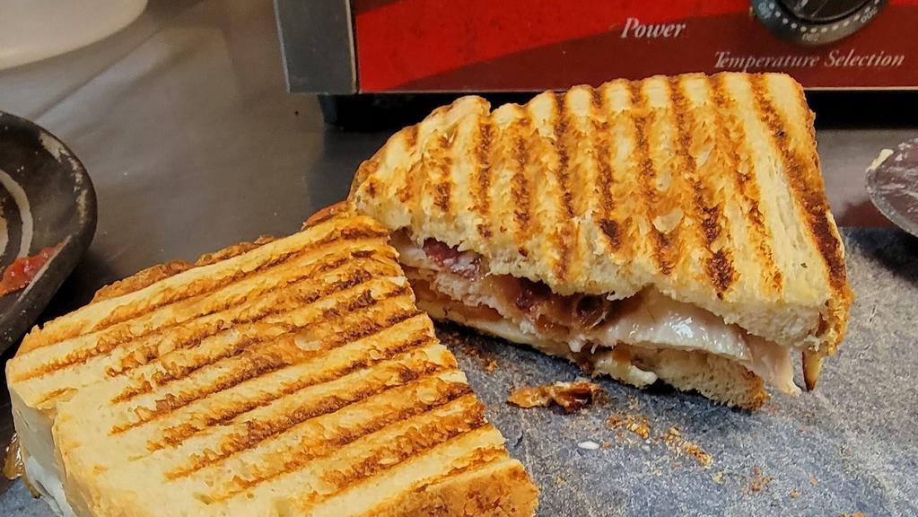 Turkey Club · Turkey, tomato, bacon, and swiss cheese, served on sourdough bread with ranch dressing