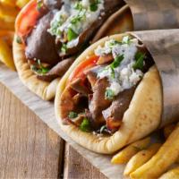 Lamb Gyro · Lamb gyro cooked with chopped onions, lettuce, and tomato.