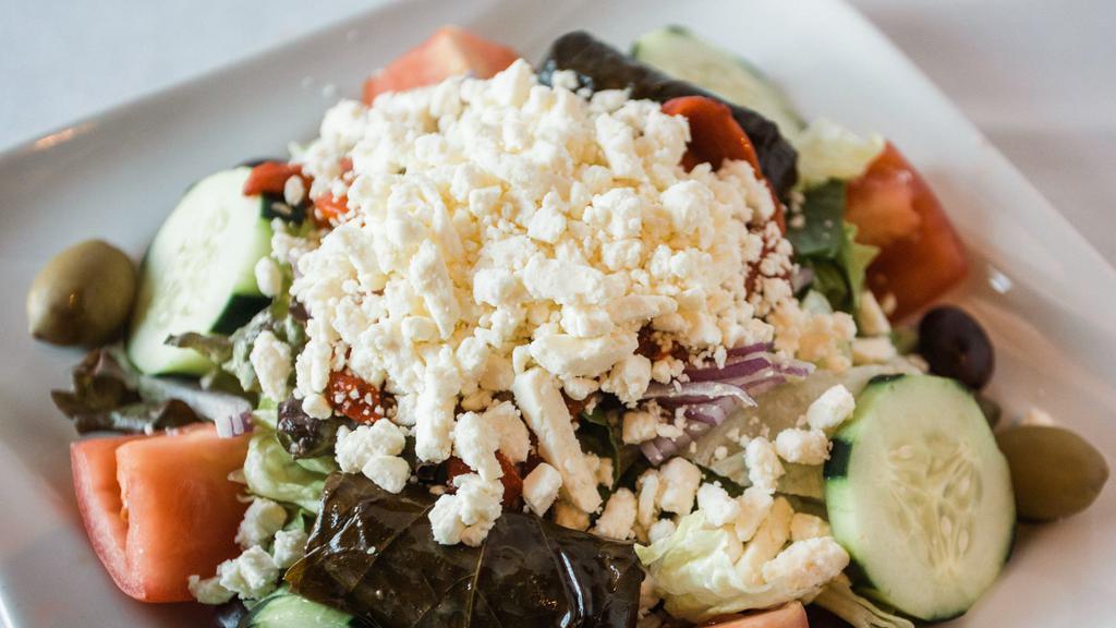 Greek Salad · mixed greens with cucumber, tomato, carrot, red onion, olives, & feta cheese in a vinaigrette dressing.