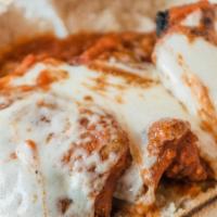 Eggplant Parmigiana · Grilled eggplant topped with our homemade tomato sauce & daiya vegan cheese served with a si...