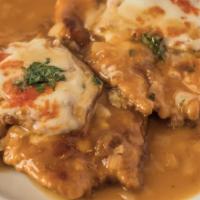 Chicken Sorrentino · topped with eggplant, prosciutto & mozzarella in a light brown sauce with onions.