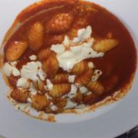 Gnocchi · Baked with fresh Mozzarella cheese in a tomato basil sauce. Served with a small house salad.