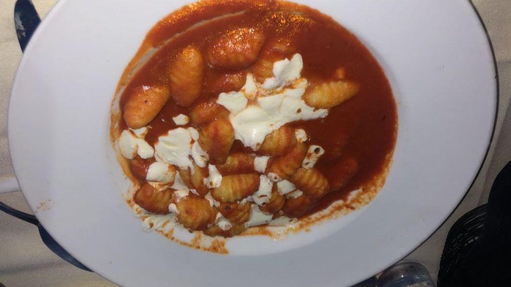 Gnocchi · Baked with fresh Mozzarella cheese in a tomato basil sauce. Served with a small house salad.