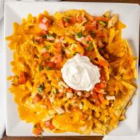 Nachos · With melted American cheese, chicken or beef, Pico de Gallo salsa, and sour cream.
