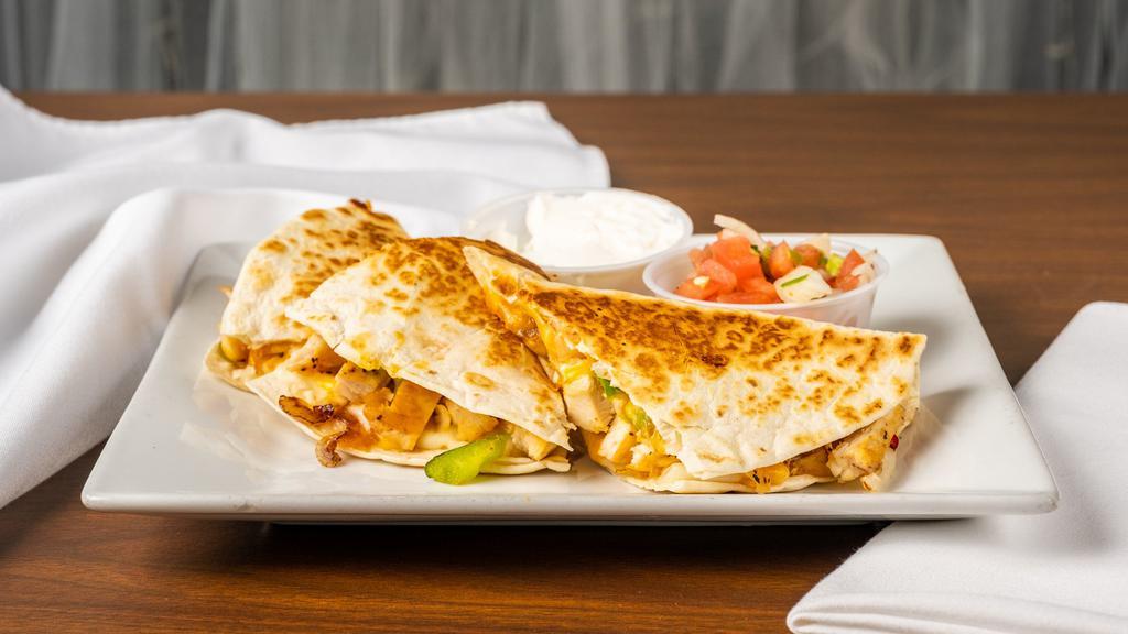 Grilled Chicken Quesadillas · Grilled chicken, cheddar cheese, peppers, and onions in a flour tortilla.