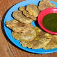 Tostones · Vegetarian. Twice fried plantains with Cilantro Pesto.